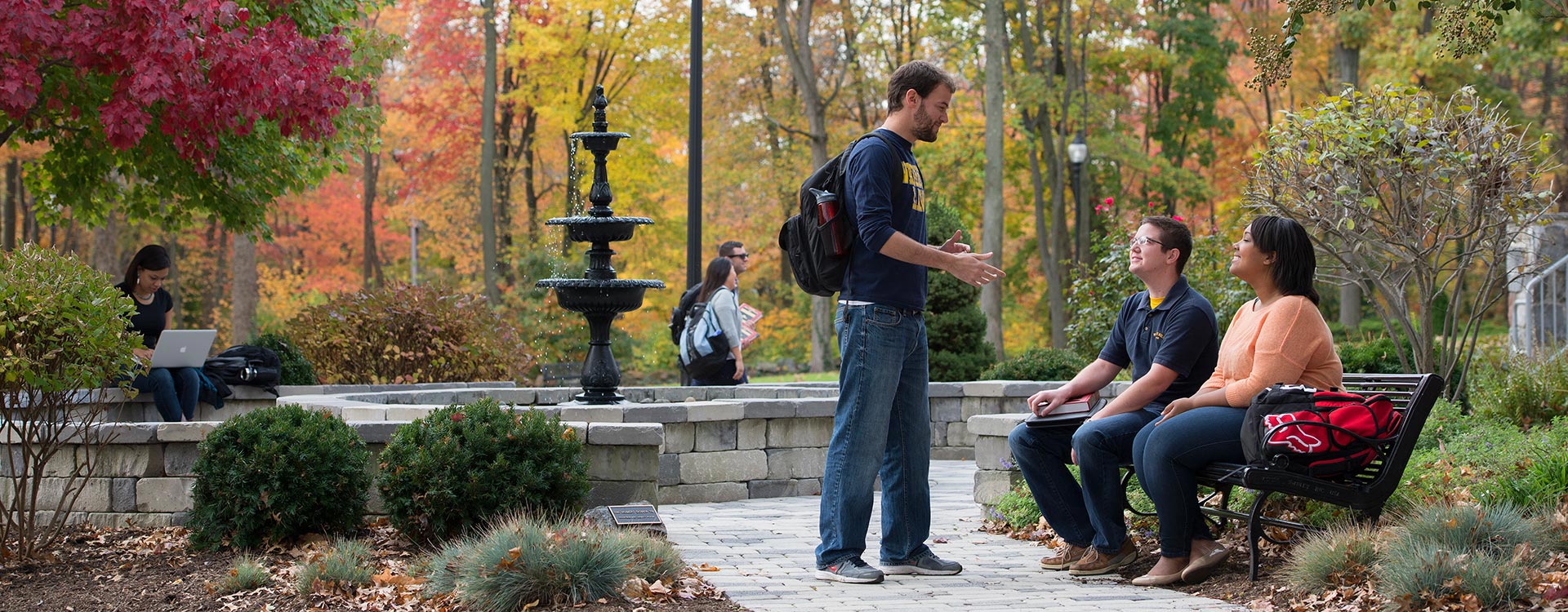 Three students conversing in a park